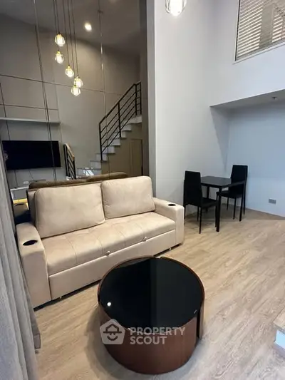 Modern living room with stylish furniture and staircase in a contemporary apartment