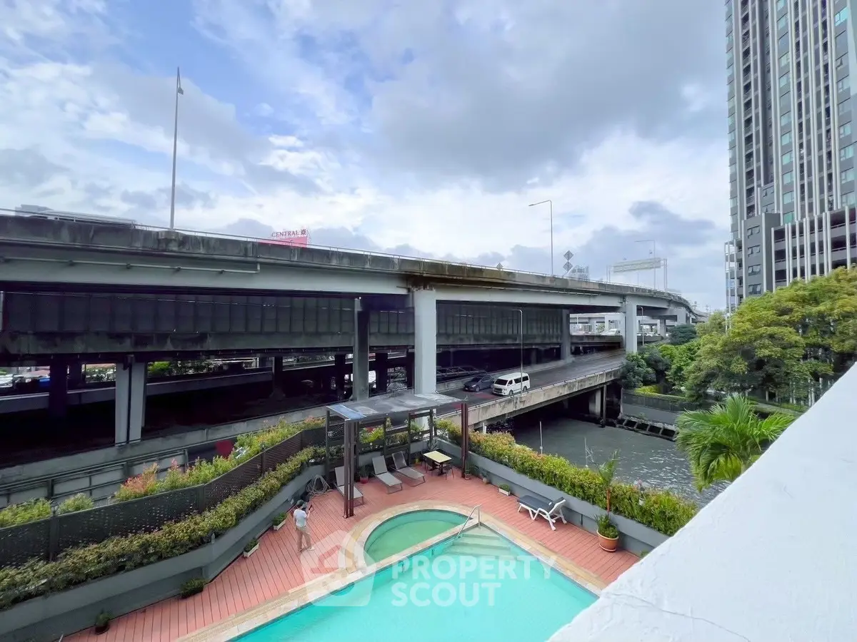 Modern urban apartment with pool and highway view, ideal for city living.