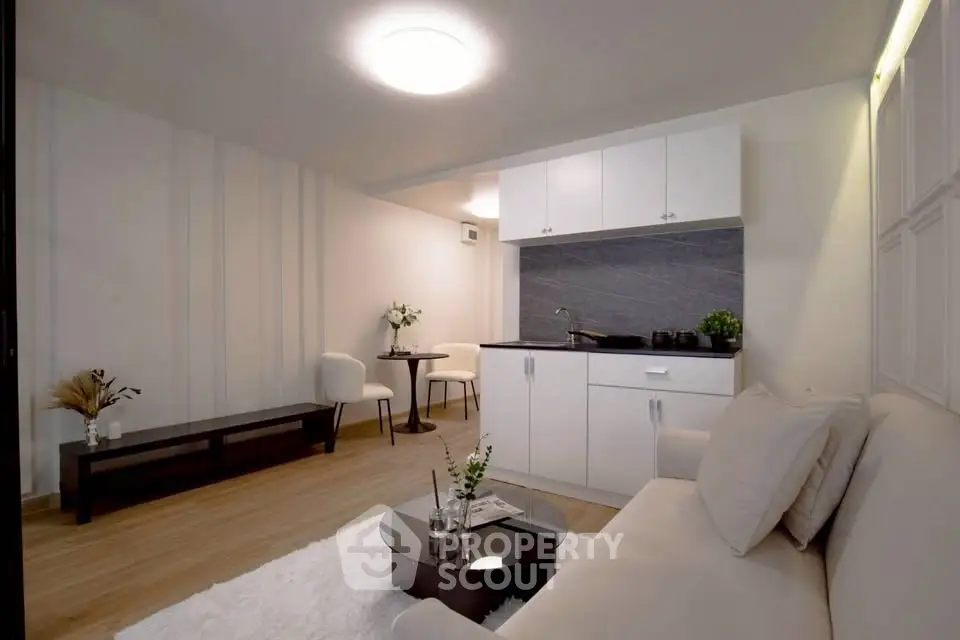 Modern living room with sleek kitchenette and stylish decor