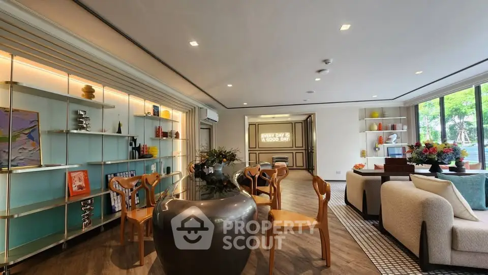 Spacious modern living room with elegant decor and large windows offering natural light.
