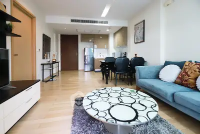 Modern living room with stylish decor and open kitchen layout in a cozy apartment.