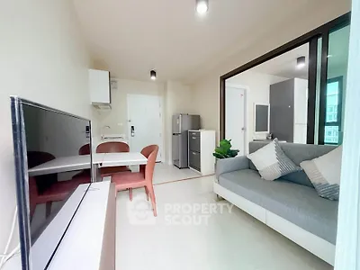 Modern living room with open layout, stylish furniture, and natural light in a contemporary apartment.