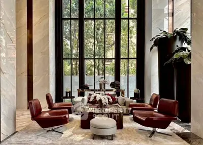 Luxurious living room with high ceilings and elegant furnishings in a modern apartment.