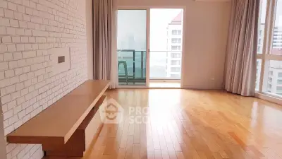 Spacious living room with hardwood floors and large windows offering city views.