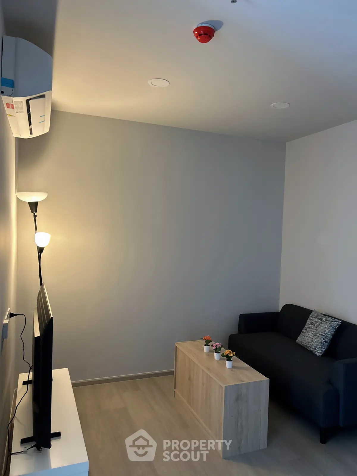 Modern living room with sleek furniture and ambient lighting, perfect for cozy relaxation.