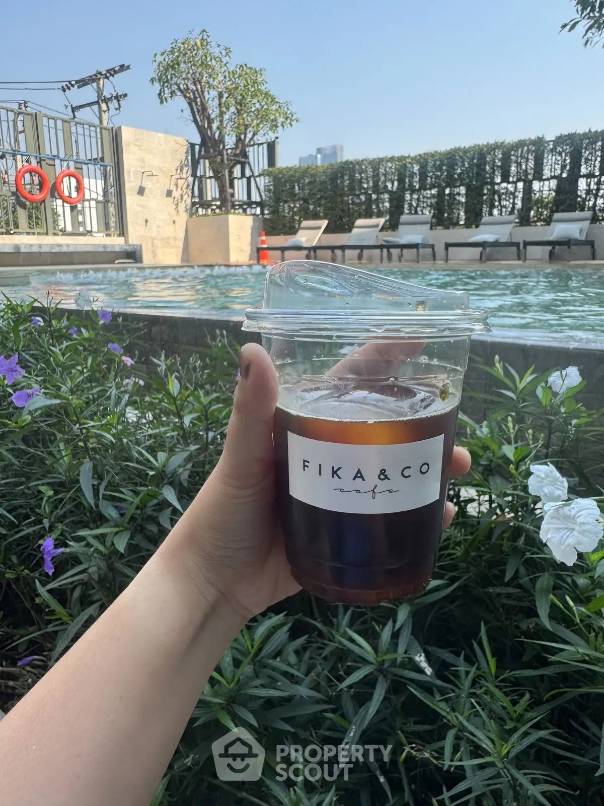 Luxurious poolside view with refreshing iced coffee, perfect for relaxation and leisure.