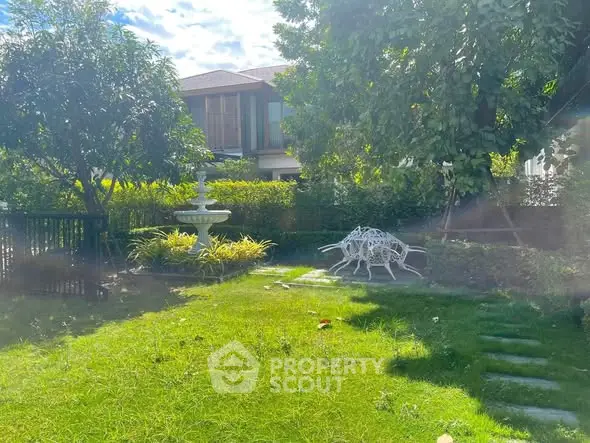 Charming garden view with lush greenery and modern outdoor seating in a serene residential setting.