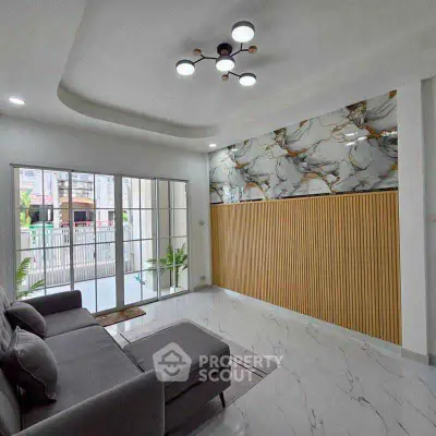 Modern living room with marble accents and large windows