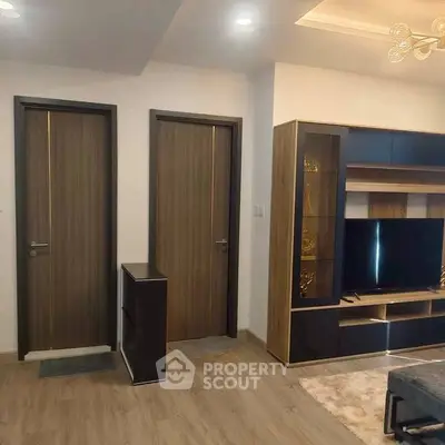 Modern living room with sleek wooden doors and stylish entertainment unit