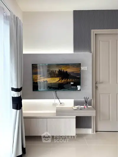 Modern living room with wall-mounted TV and stylish decor