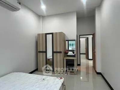 Modern bedroom with sleek wardrobe and minimalist decor in a stylish apartment.