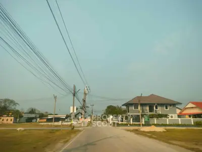 Charming suburban street with modern houses and clear blue sky