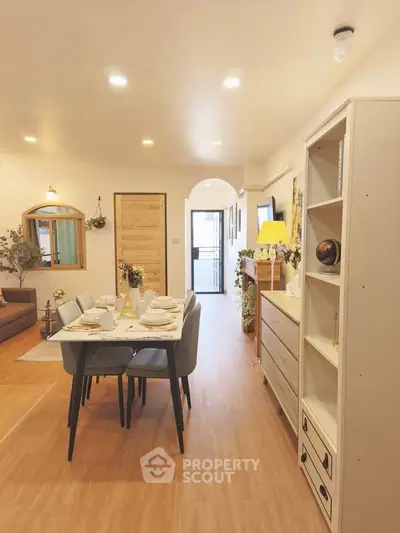 Charming open-plan living and dining area with modern decor and wooden flooring.