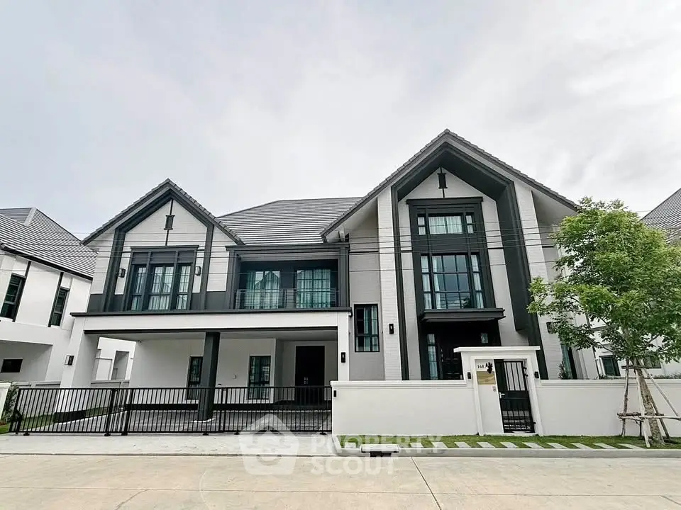 Stunning modern two-story house with sleek design and spacious driveway in a serene neighborhood.