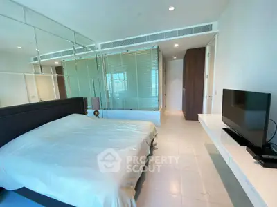 Modern bedroom with sleek design and large mirror wall