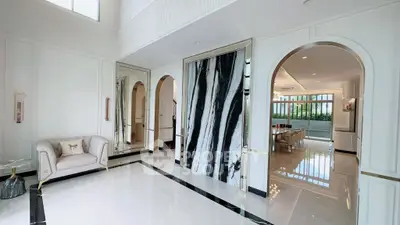 Luxurious open-plan living area with elegant marble accents and modern furnishings.