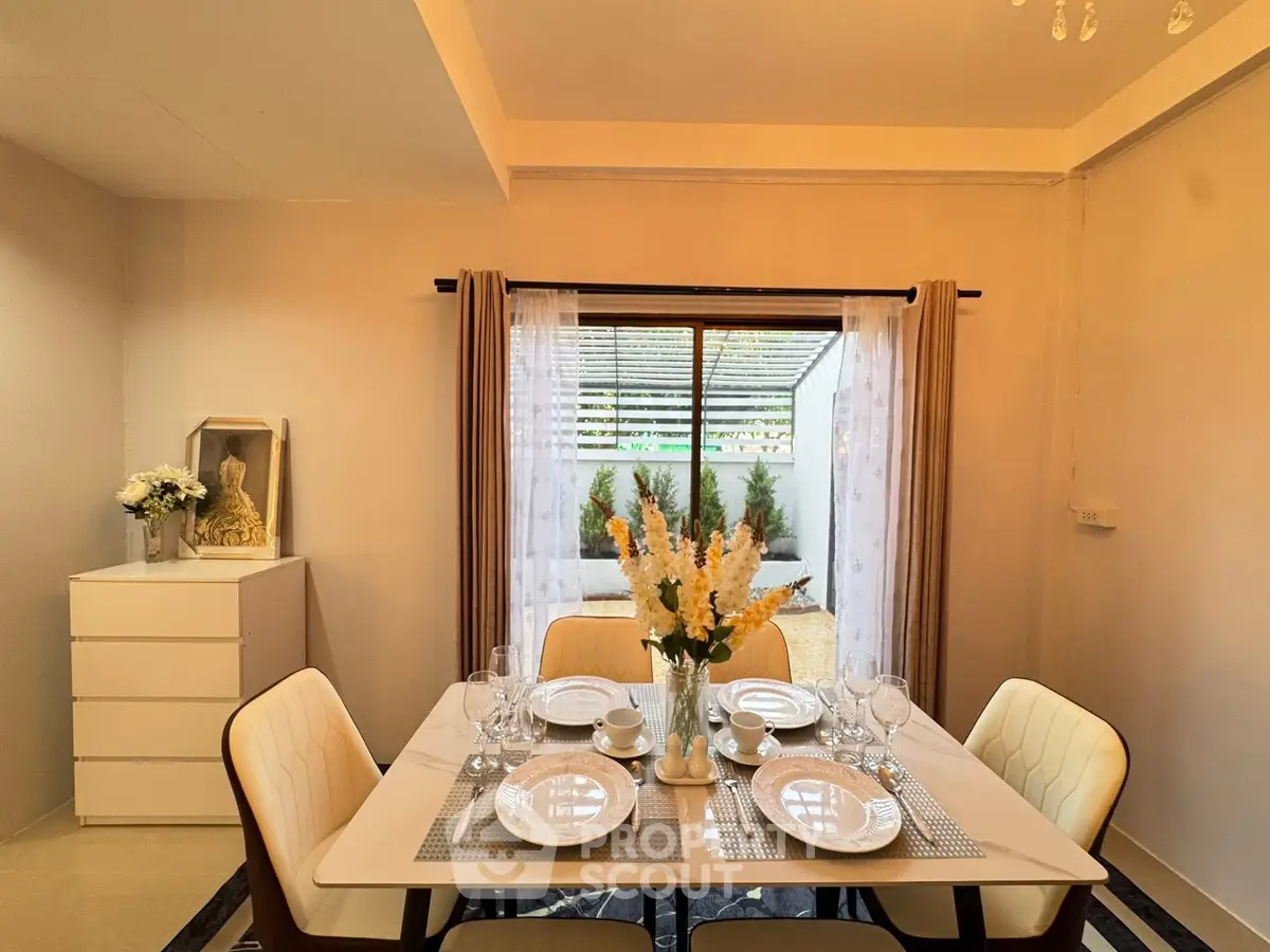 Elegant dining area with modern decor and garden view