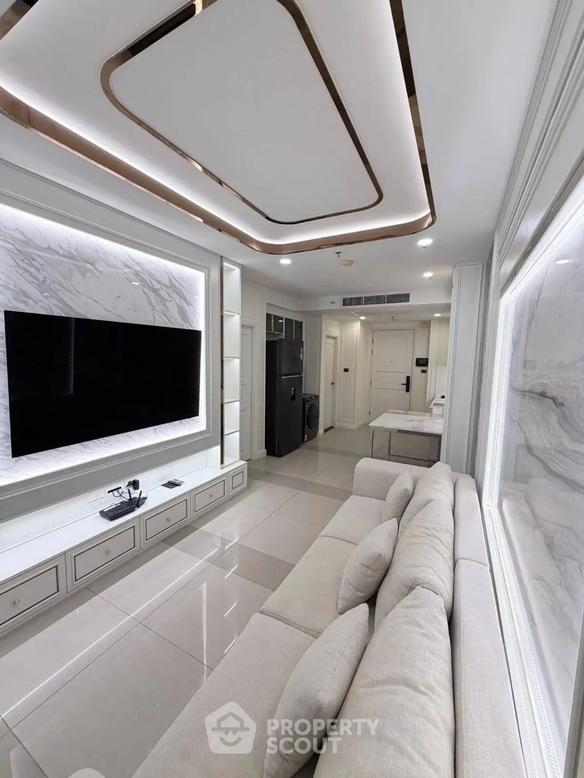 Luxurious modern living room with sleek design and large TV, perfect for entertainment.