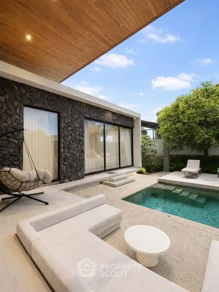 Luxurious modern patio with private pool and stylish outdoor seating area.