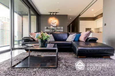 Luxurious living room with plush seating and modern decor, featuring floor-to-ceiling windows and elegant lighting.