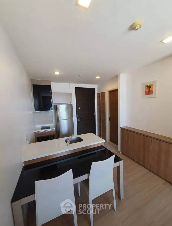 Modern kitchen with sleek design, featuring stainless steel appliances and elegant dining area.