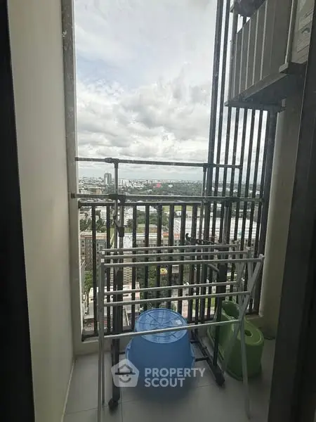 Compact balcony with city view, ideal for urban living and outdoor relaxation.