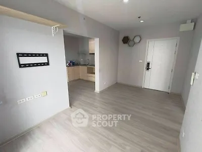 Modern unfurnished apartment with open layout and sleek wooden flooring.
