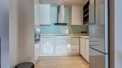 Modern kitchen with sleek white cabinets and stainless steel appliances