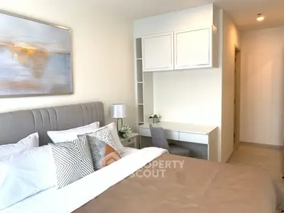 Modern bedroom with stylish decor and cozy ambiance, featuring a comfortable bed and elegant artwork.