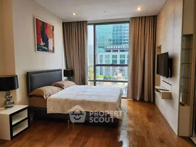 Luxurious bedroom with modern decor and city view, featuring hardwood floors and stylish furnishings.