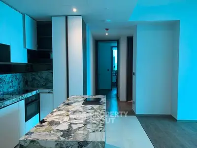 Modern kitchen with marble countertops and sleek cabinetry in a contemporary apartment.
