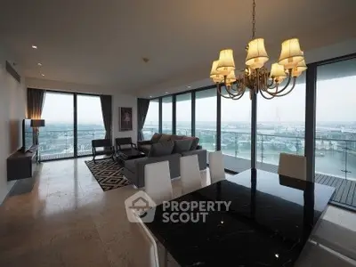 Luxurious living room with panoramic city view and elegant chandelier.