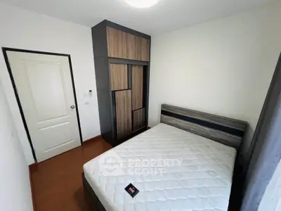 Cozy bedroom with modern wardrobe and comfortable bed in a stylish apartment.