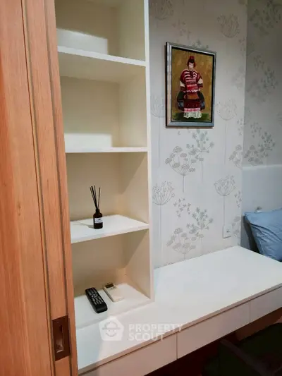 Cozy bedroom with built-in shelving and stylish wallpaper
