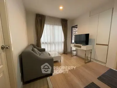 Modern living room with cozy sofa and large window, perfect for relaxation.