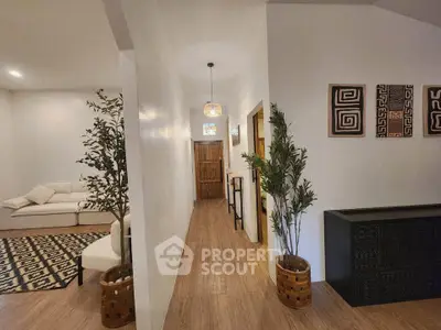 Stylish hallway with modern decor and cozy living room in a contemporary home.