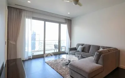 Spacious living room with large windows and modern sectional sofa