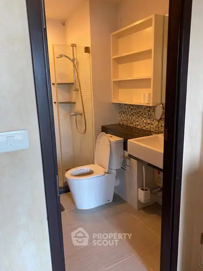 Modern bathroom with sleek fixtures and stylish tile accents in a contemporary apartment.