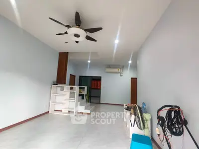 Spacious modern living room with ceiling fan and open layout