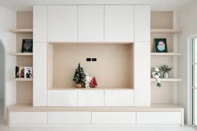 Modern living room with built-in shelving and festive decorations