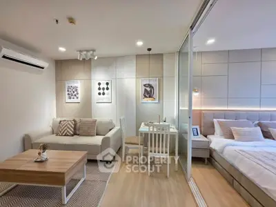 Modern open-plan living room and bedroom with stylish decor and neutral tones.