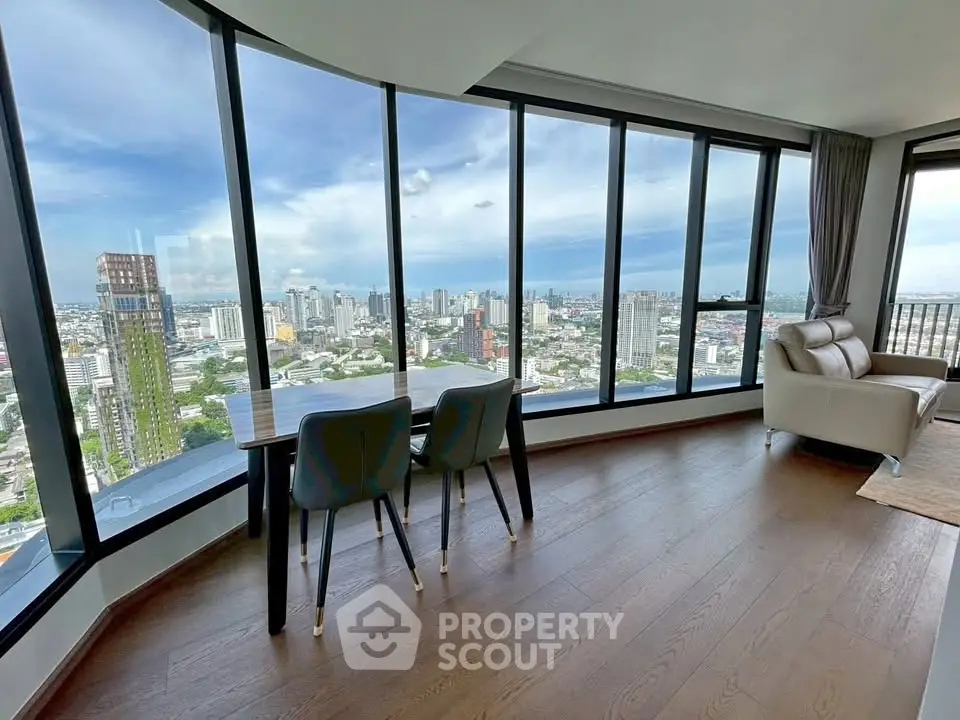 Stunning high-rise living room with panoramic city views and modern furnishings.