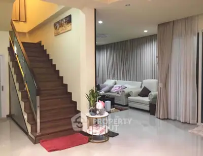 Elegant living room with modern staircase and cozy seating area