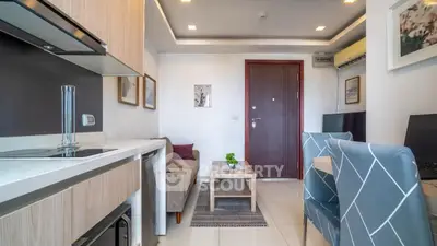 Modern living room with stylish decor and compact layout, featuring a cozy sofa and elegant dining area.