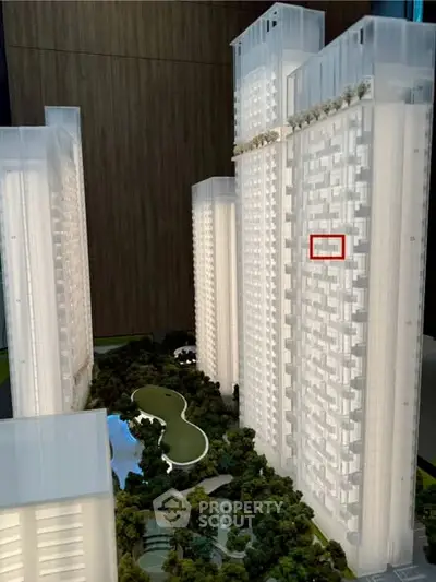 Stunning architectural model of modern high-rise residential complex with lush green landscaping.