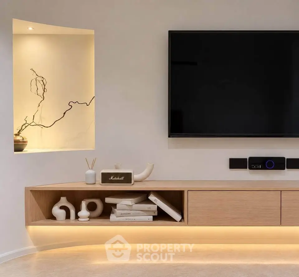 Modern living room with sleek TV setup and stylish shelving