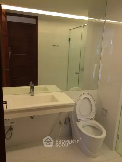 Modern bathroom with sleek fixtures and glass shower enclosure