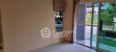 Spacious room with large window and garden view, perfect for natural light lovers.