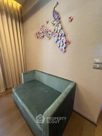 Stylish living room corner with elegant wall art and plush green sofa, perfect for modern interiors.