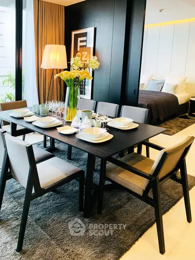 Luxurious dining area with elegant table setting and cozy bedroom view, perfect for modern living.